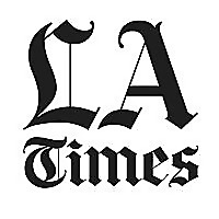 Letter LA above the word Times